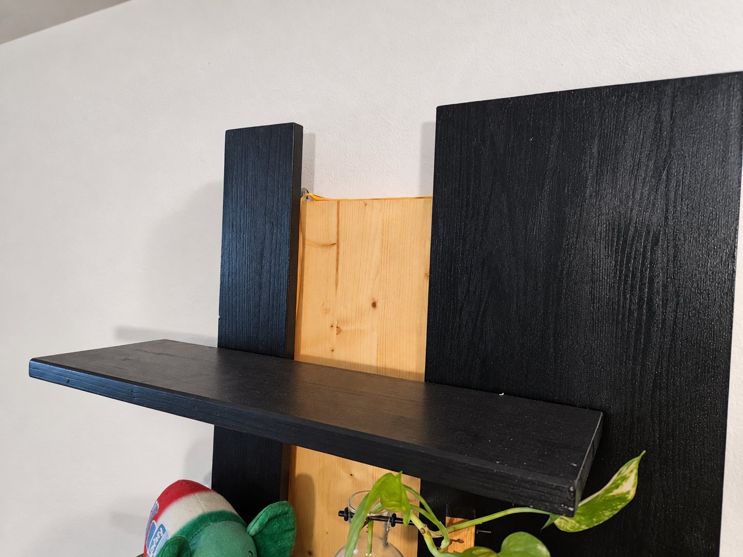 Detail of the top of the shelf, with the recessed centre panel between the uprights